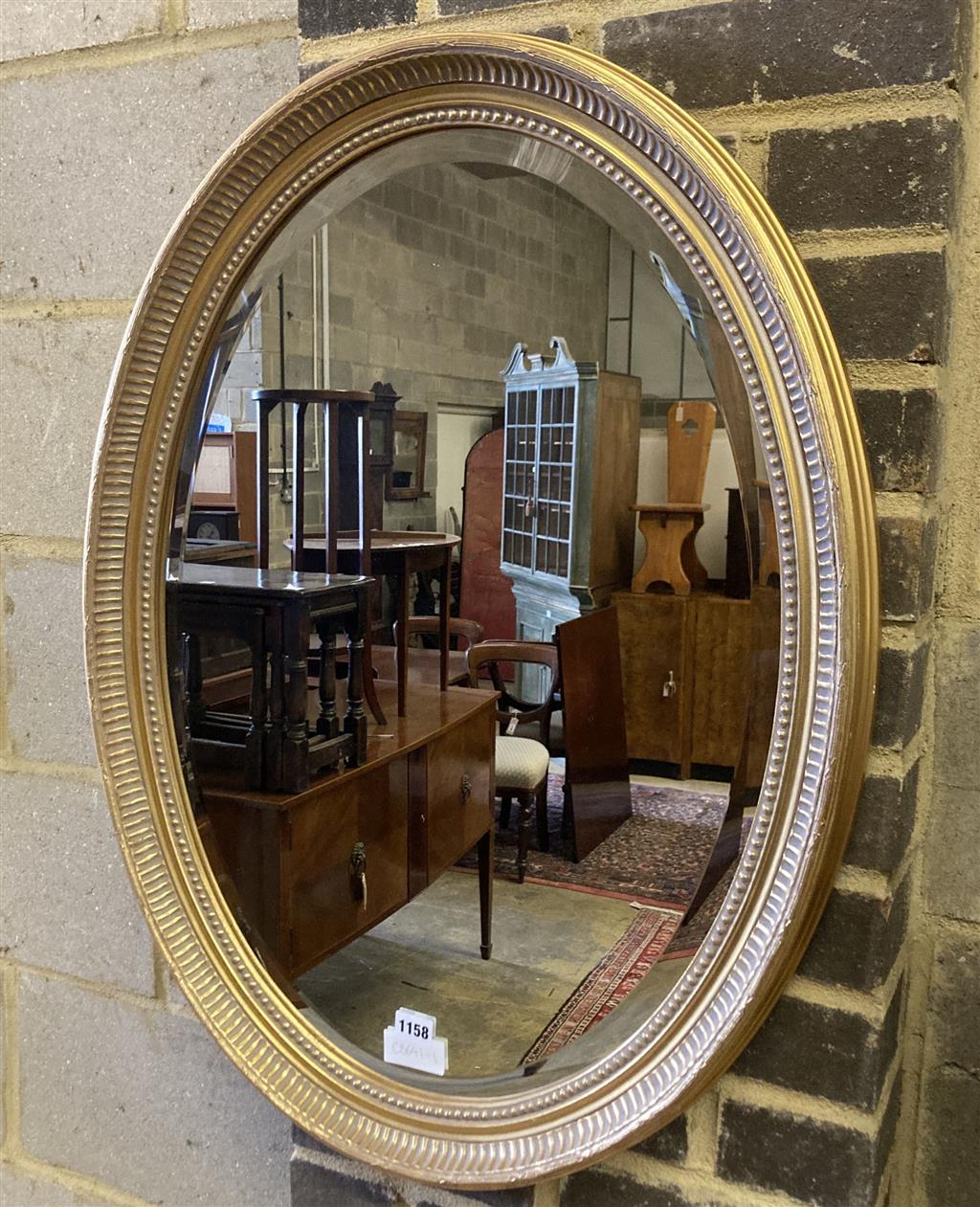 An oval gilt framed bevelled wall mirror, width 58cm height 78cm